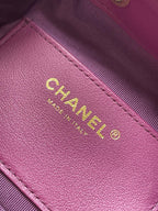 Purple Chanel leather patch with gold logo text on bag panel