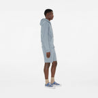 Plaid sneakers on feet with beige socks, blue laces and white rubber sole