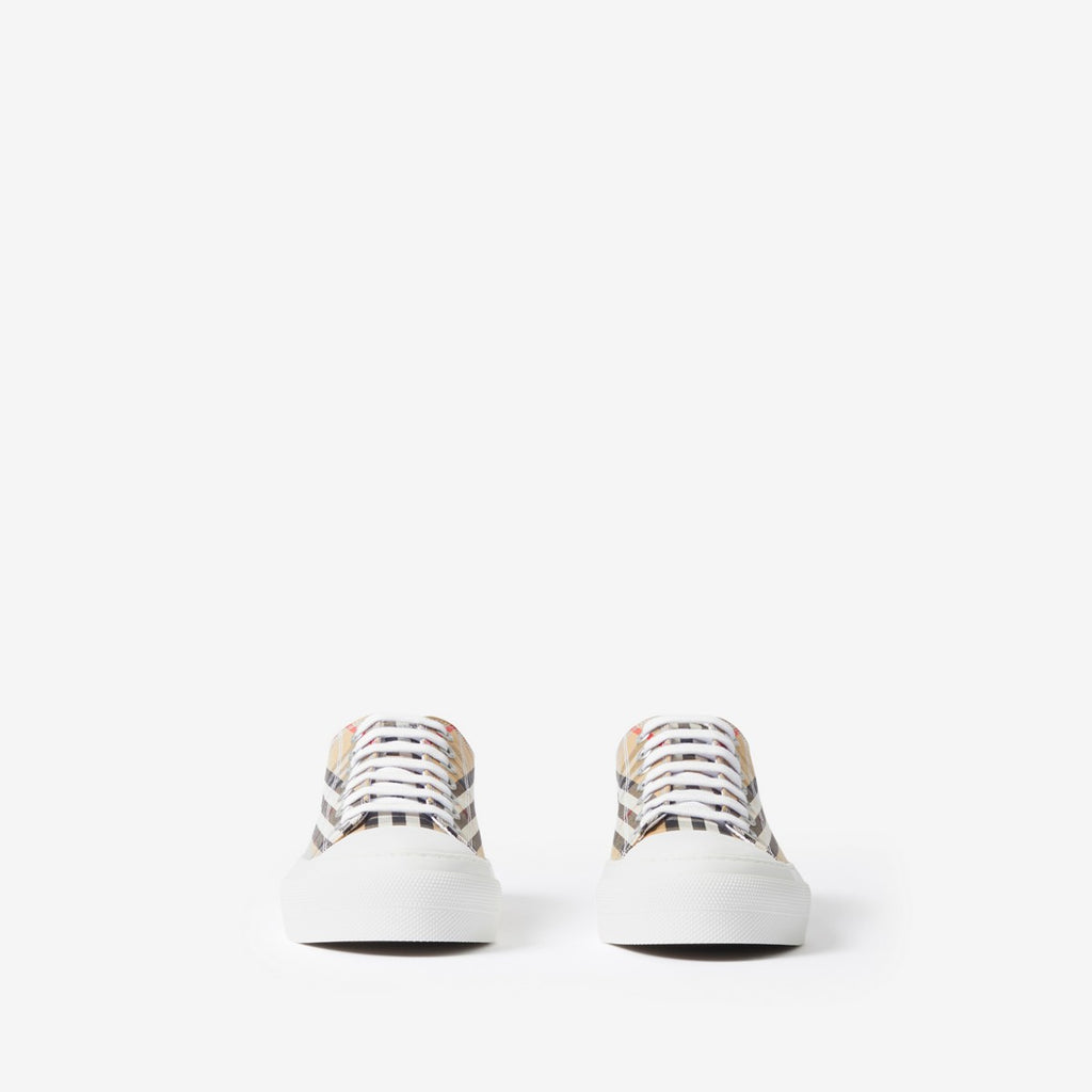 Pair of low-top sneakers with beige plaid uppers and white lace trim