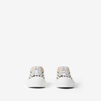 Pair of low-top sneakers with beige plaid uppers and white lace trim