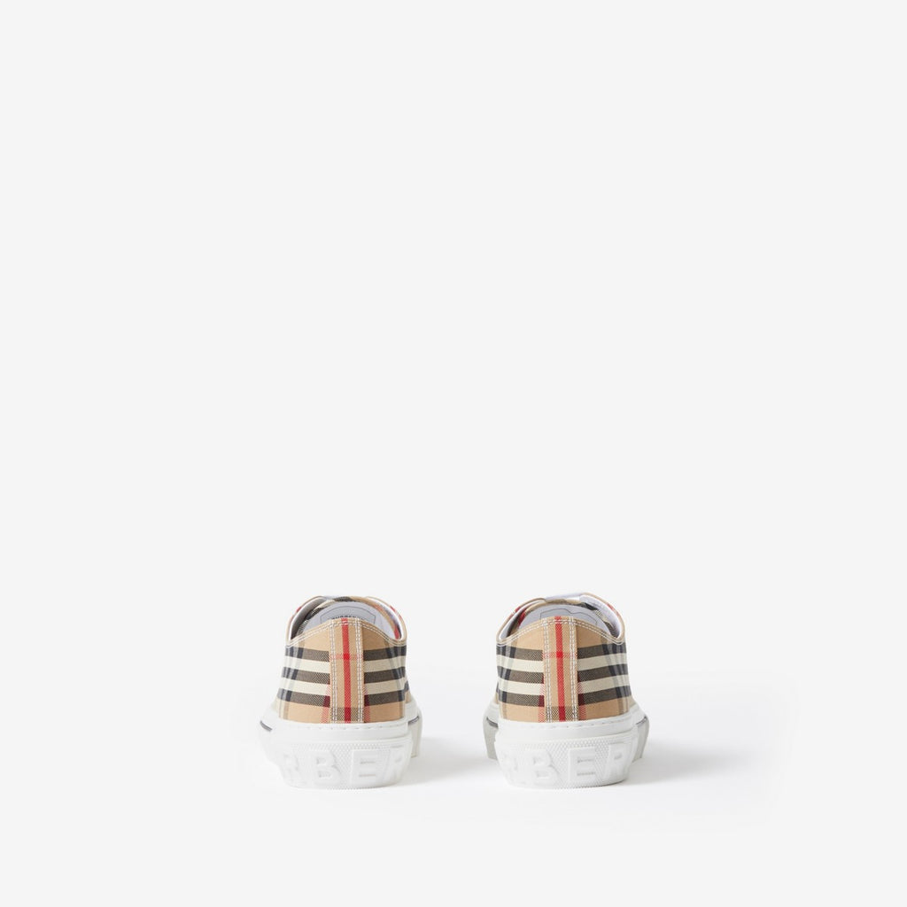Pair of low-top sneakers, beige plaid heel panels with embossed sole text