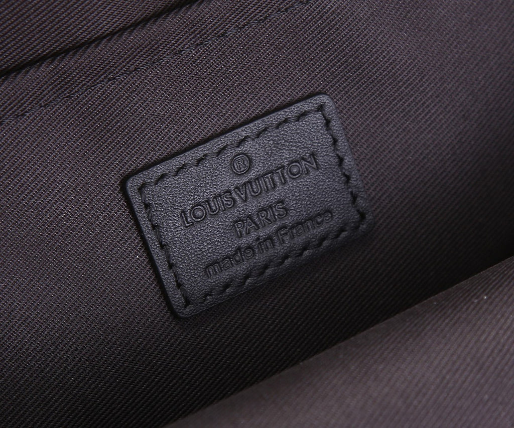 Men's Louis Vuitton mini sling bag interior label, Louis Vuitton Paris embossed text.