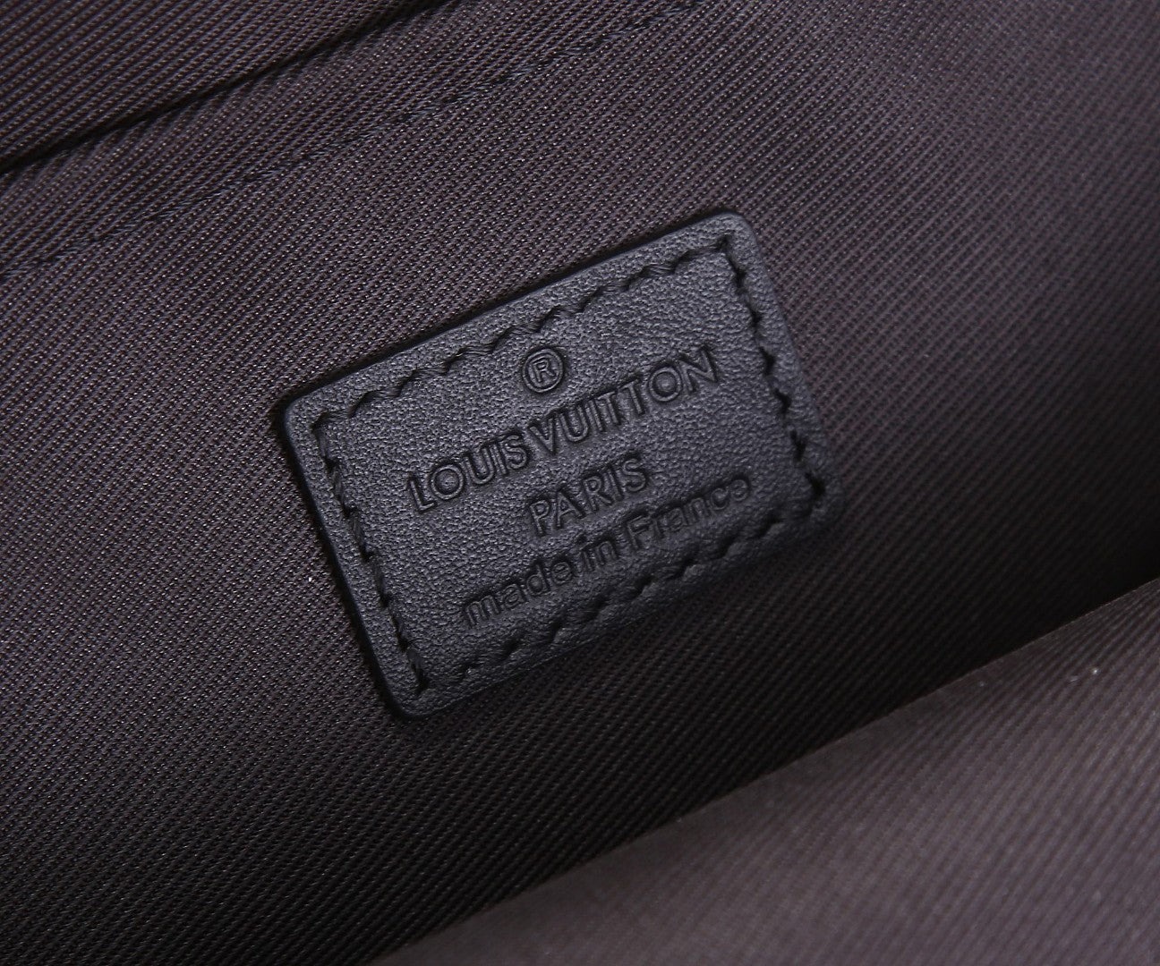 Black Louis Vuitton Paris leather label patch on the bag exterior