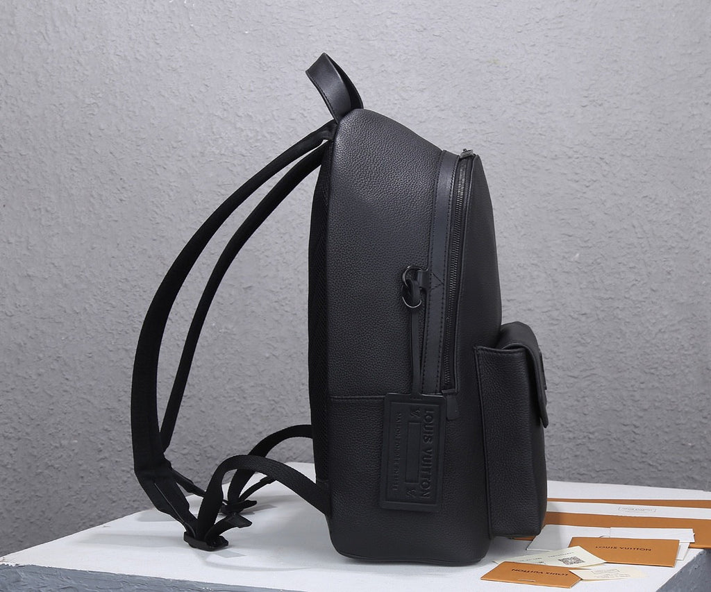 Louis Vuitton men’s black leather backpack from side view with adjustable shoulder straps