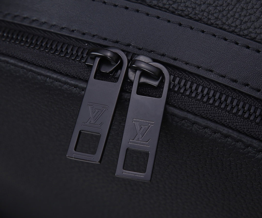 Louis Vuitton men’s backpack zipper close-up with two metal pull tabs