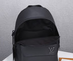 Louis Vuitton men’s black leather backpack shown from front with zip pocket and LV emblem