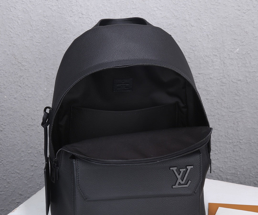 Louis Vuitton men’s black leather backpack shown from front with zip pocket and LV emblem
