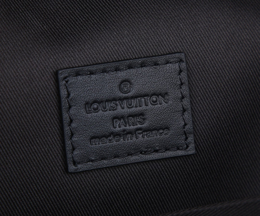 Louis Vuitton men’s backpack fabric label patch reading Louis Vuitton Paris made in France