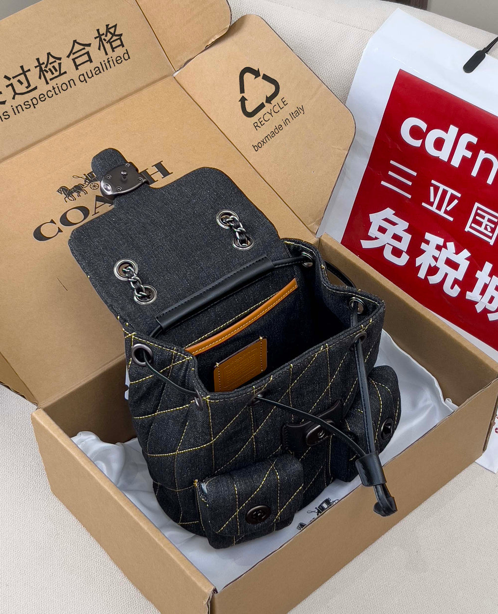 Coah bag dark denim crossbody with front pocket, metal clasp, and chain strap
