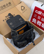 Coah bag dark denim crossbody with front pocket, metal clasp, and chain strap