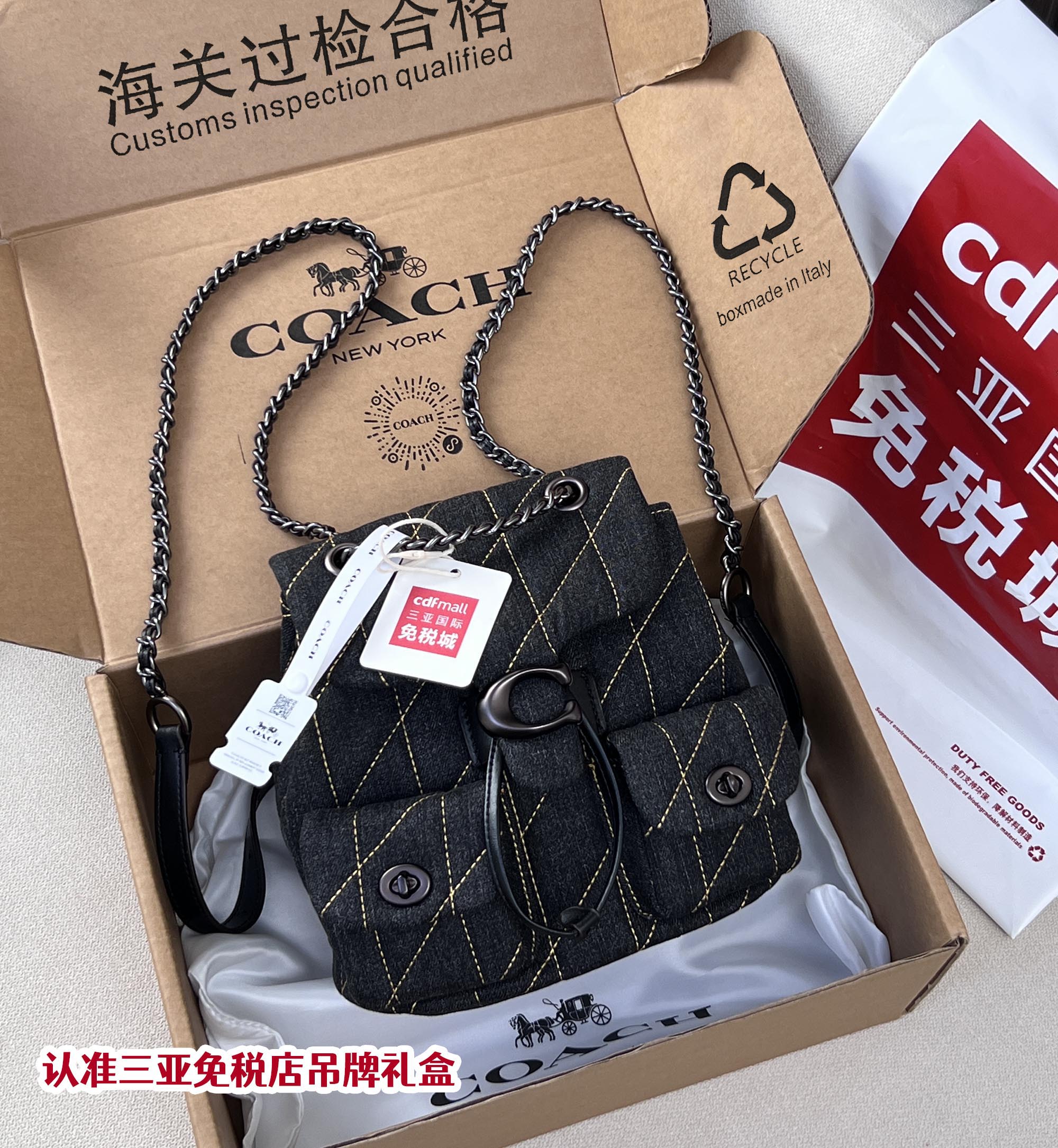 Coah bag denim crossbody with chain strap, front flap, metal ring and tags