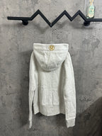Light gray zip-up hoodie back view with hood and small circular chest logo