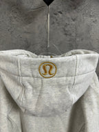 Light gray hoodie hood with gold circular logo patch