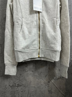 Back view of heather gray zip-up hoodie with central gold zipper
