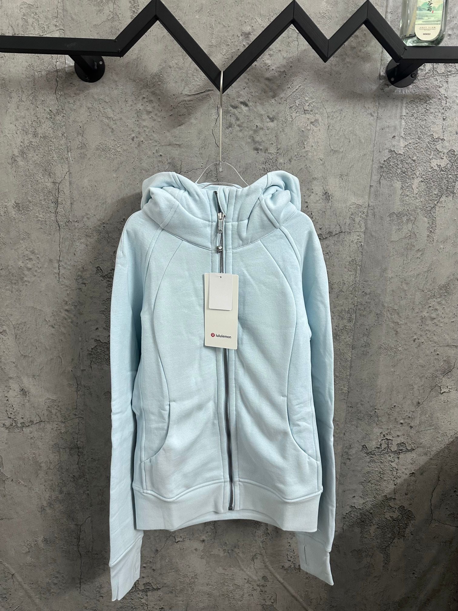 Light blue zip-up hoodie with hood and front zipper