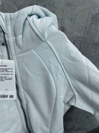 Light blue hoodie sleeve with hood and stitched panel seams