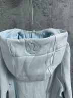 Light blue hoodie hood with embroidered logo patch