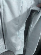 Light blue hoodie with curved kangaroo pocket and side panels