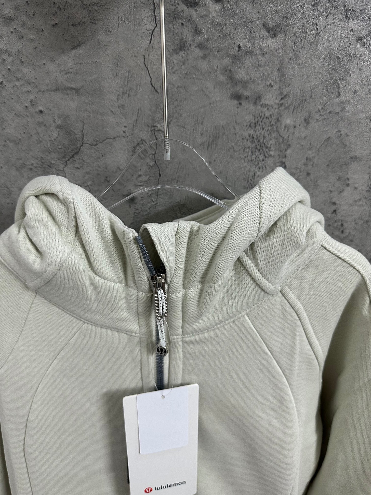 Off-white zip-up hoodie hood with metal zipper and drawstring detail