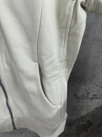 Off-white zip-up hoodie side view with front seam and ribbed cuff