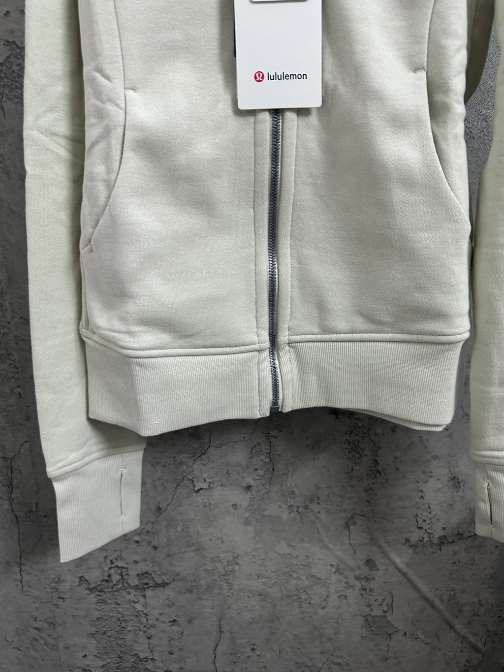 Off-white zip-up hoodie with kangaroo pocket and front zipper