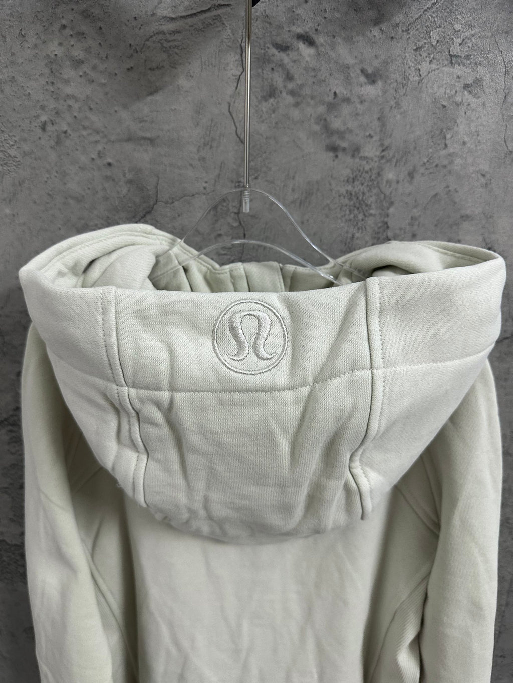 Off-white zip-up hoodie with back hood logo and adjustable drawstrings