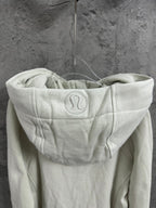 Off-white zip-up hoodie with back hood logo and adjustable drawstrings