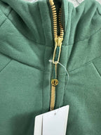 Green hoodie with gold front zipper and zipper pull detail