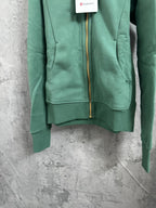 Green zip hoodie with hood, gold zipper, and front pouch pocket