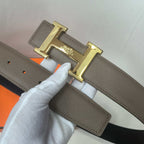 Taupe leather belt with gold H buckle and punched sizing holes on the strap