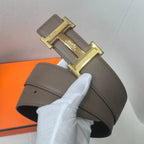 Hermes leather belt in taupe with gold H buckle, textured strap and stitched edge