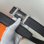 Black leather belt detail: silver Hermes buckle on textured strap