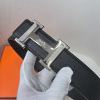 Black leather belt with silver Hermes buckle, textured leather finish