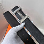 Black leather belt close-up of textured strap and silver buckle hardware