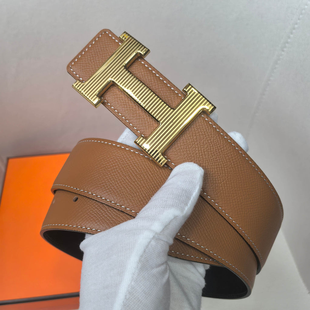 Brown leather belt with gold H-shaped buckle, stitched edges