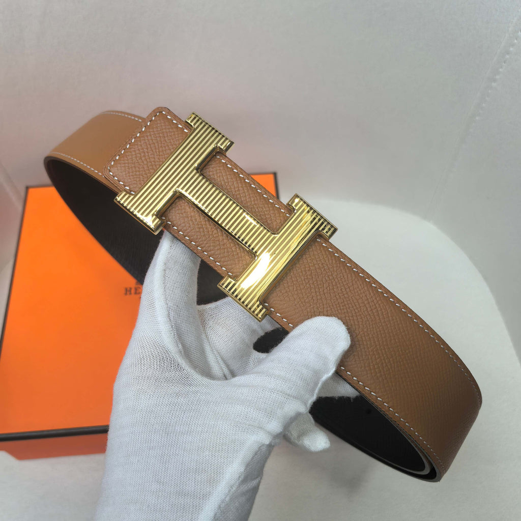 Brown leather belt with gold buckle and wide end loop