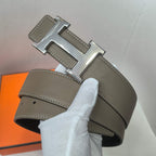 Leather belt with silver H buckle and taupe textured strap, white stitching