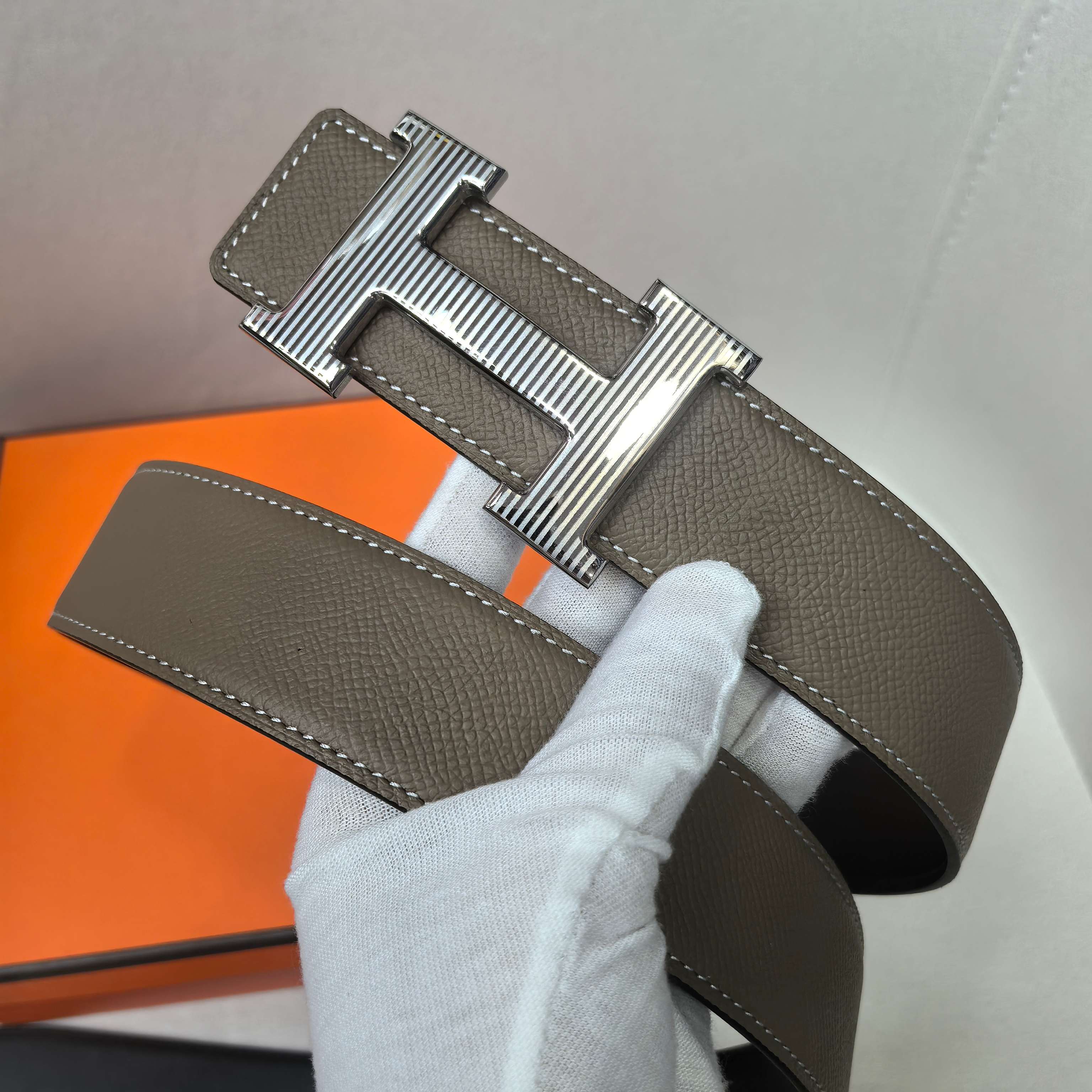 Leather belt with silver H buckle, taupe strap and stitched edge