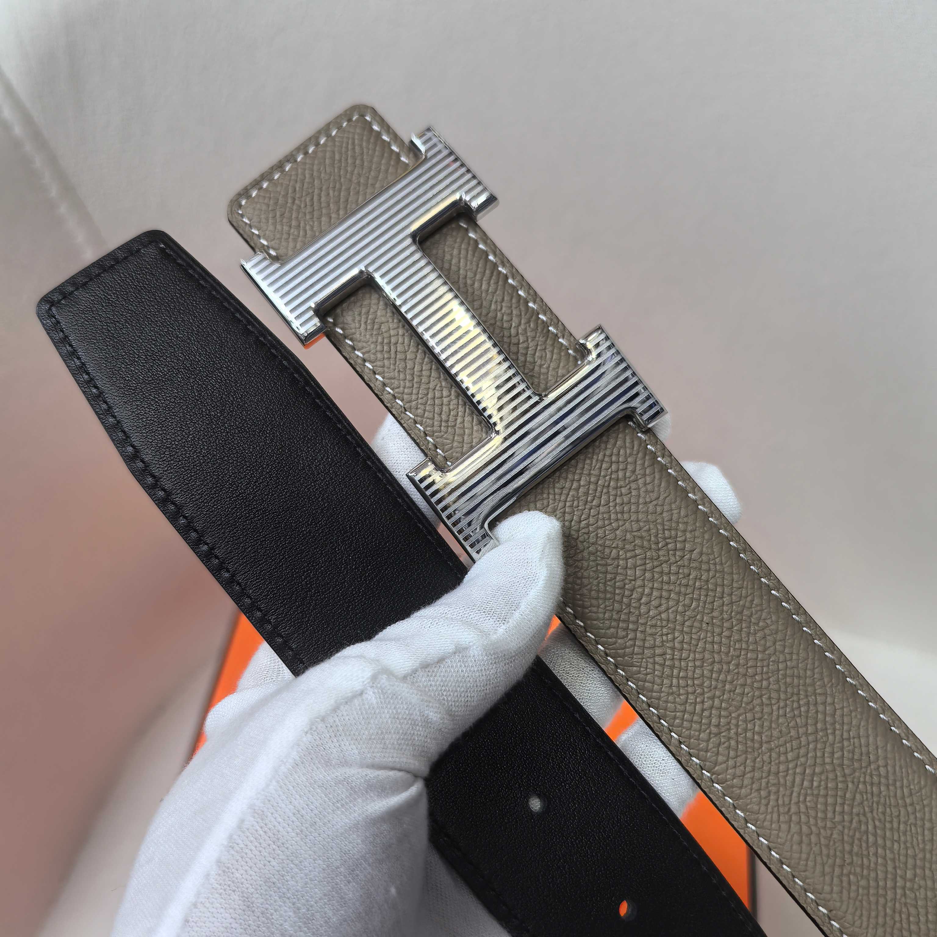 Leather belt with silver H buckle, taupe and black sides with stitched edges