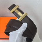 Black leather belt with gold-tone H buckle, textured strap and stitched edges.