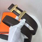Black leather belt with gold-tone H buckle and foldover strap, stitched edges.