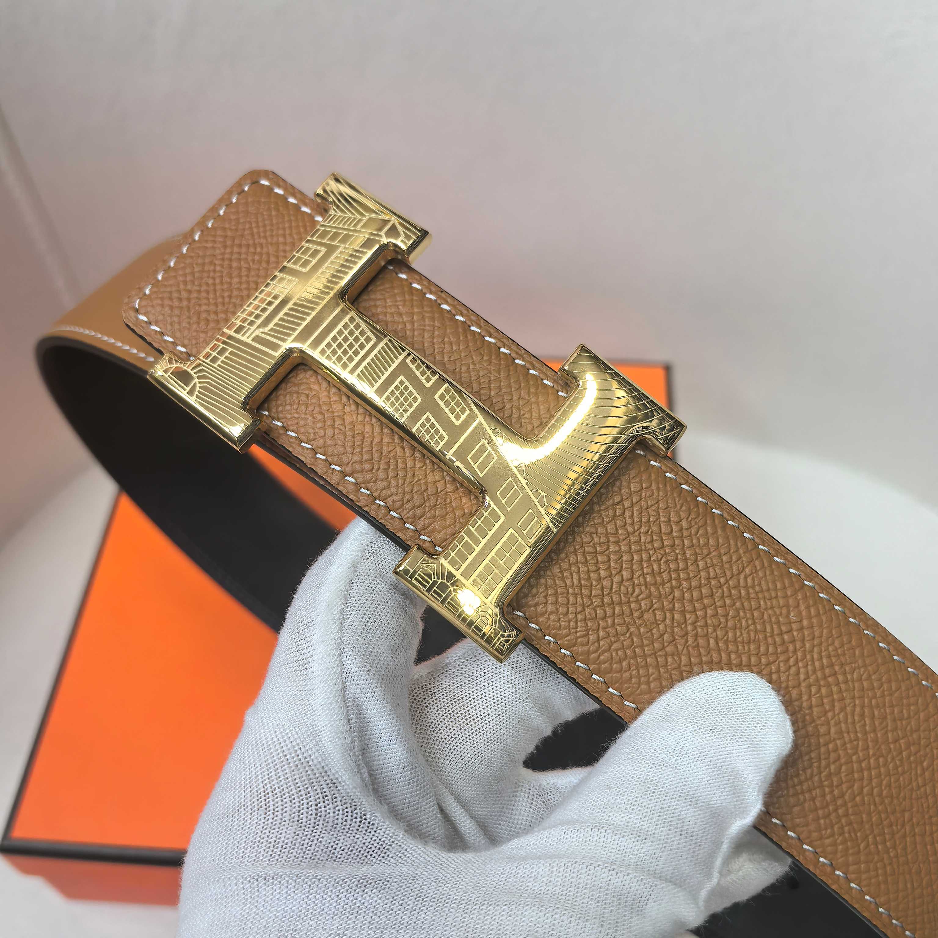 Brown leather belt with gold buckle and front keeper strap