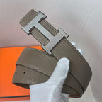 Brown leather belt with silver H buckle and contrast-stitched edges