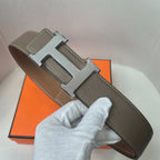 Brown leather belt with silver H buckle and stitched strap with pin slot