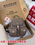 Coach mini backpack bag in taupe pebbled leather, front flap and small pockets