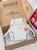 White mini top-handle bag with front flap and dual shoulder straps