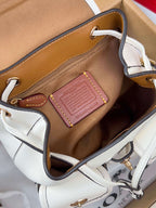 White mini backpack interior with zip pocket and leather patch label