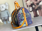 Louis Vuitton handbag with dark navy check pattern, colorful graphic panel, and orange top handle.
