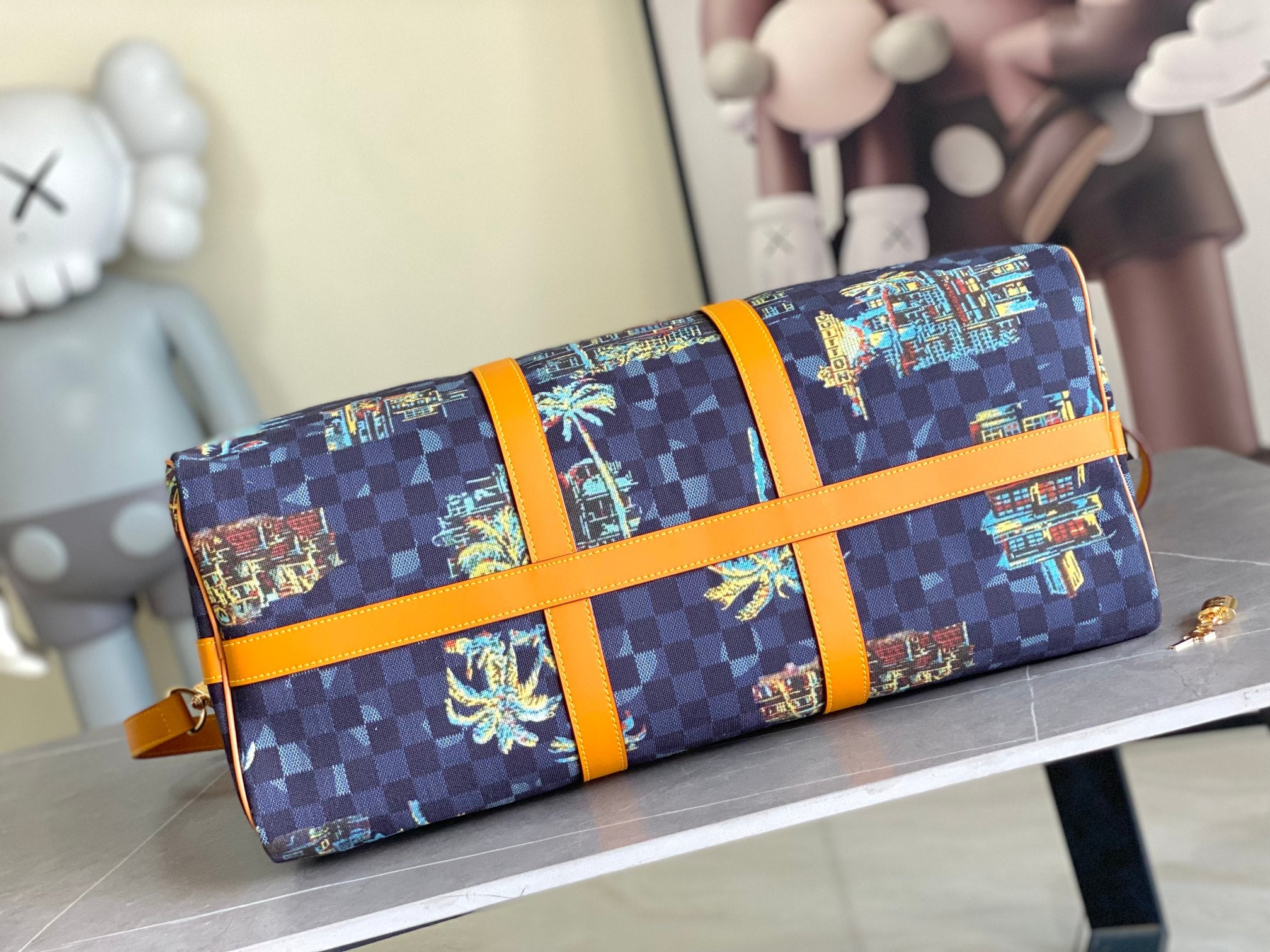 Louis Vuitton handbag with navy check canvas, colorful horizontal panels, and bright orange cross strap.