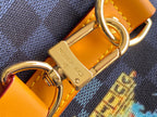 Gold clasp hardware and embossed “LOUIS VUITTON” plaque on orange leather tab.